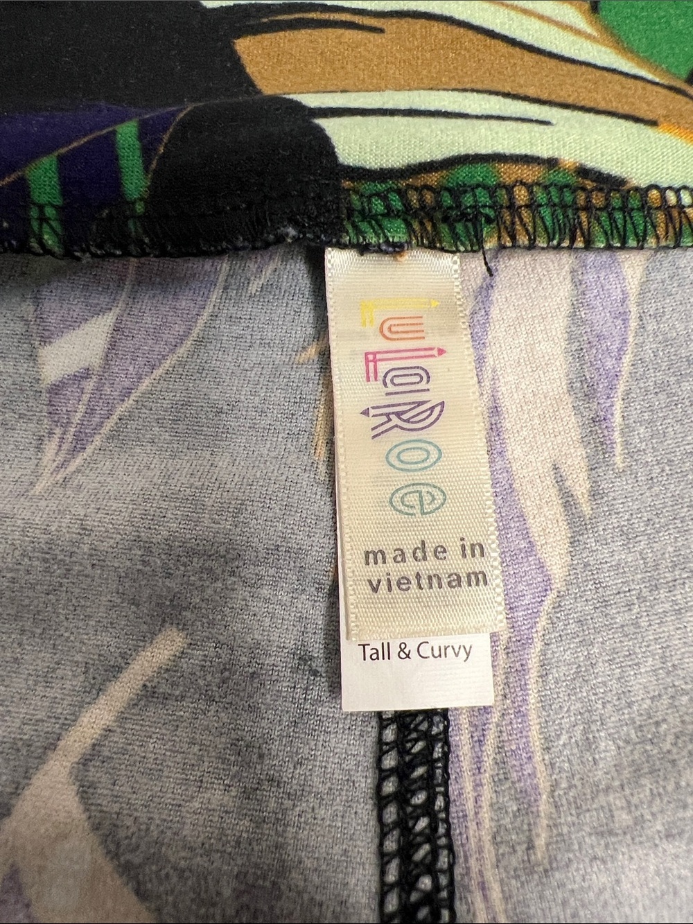 LuLaRoe Black Feather Print Leggings with Green, Purple & Gold Accents - Picture 5 of 5